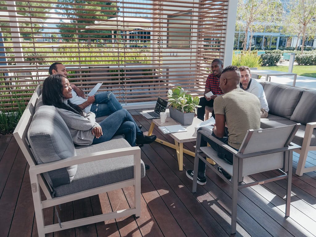 Group meeting in outdoor lounge area.